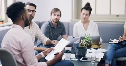 4k video footage of a group of young businesspeople having a meeting in a modern office