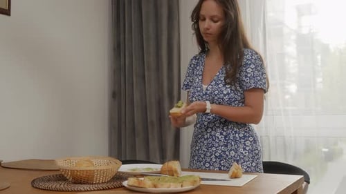 Woman Preparing Healthy Sandwiches in Sunny Home