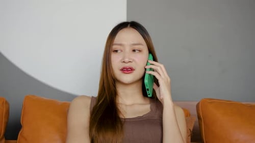 Woman Talking on Phone on Sofa