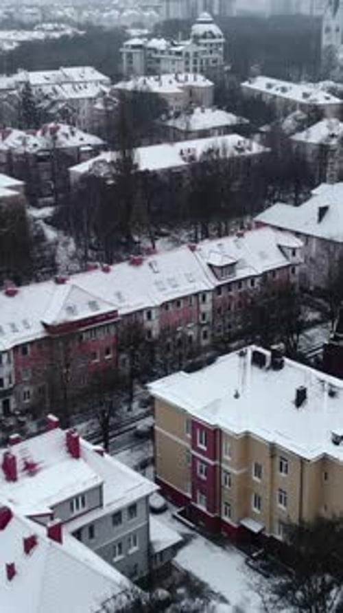 Aerial Drone Flying Over Snowy European City Rooftops Media