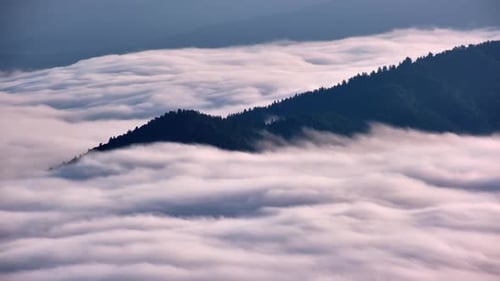 Timelapse of Mountain Peaks Rising Above Moving Sea of Clouds in Morning Inversion