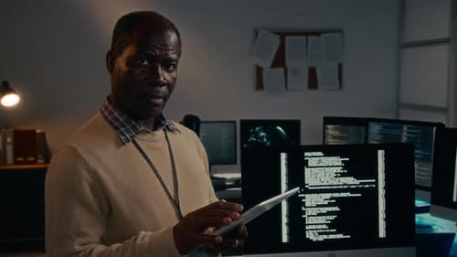 Portrait of Black Male Data Protection Specialist with Tablet in Office