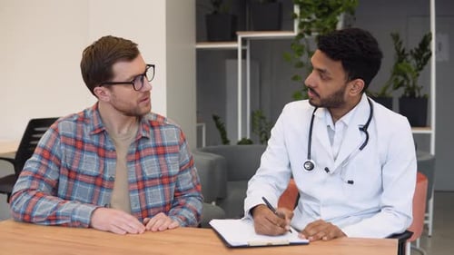 Patient Consults with Doctor in Modern Office