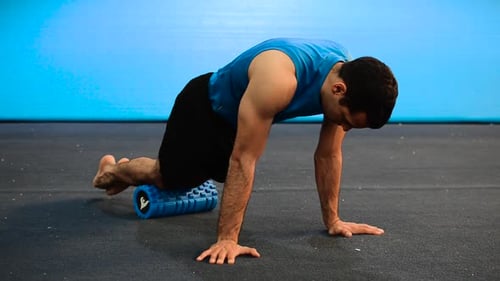 Man Using Foam Roller for Leg Muscle Therapy