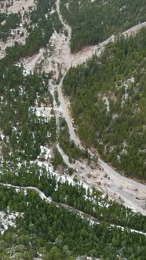 Vertical Video Aerial Winter Wonderland Majestic Mountains River and Scenic Waterfalls