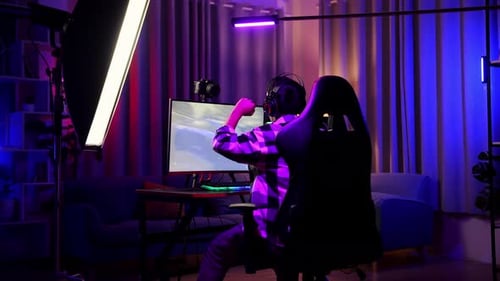 Young Adult Plays Car Racing Game at Home