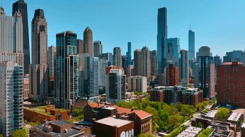 A wall of towers surrounds the area with multi-storied buildings in the green park