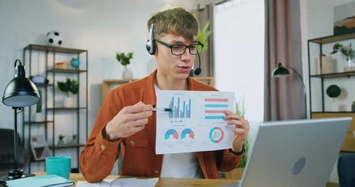 Young Man Presents Charts During Online Meeting