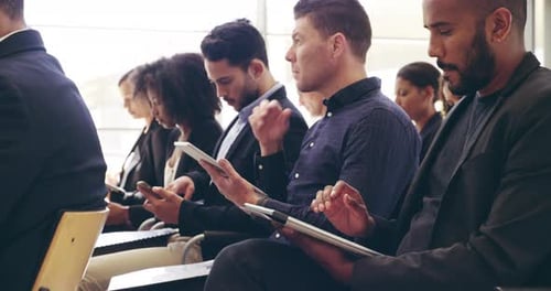 4k video footage of businesspeople sitting in a convention center during a conference