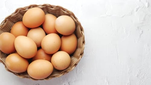 Top View of Eggs in a Bowl on White
