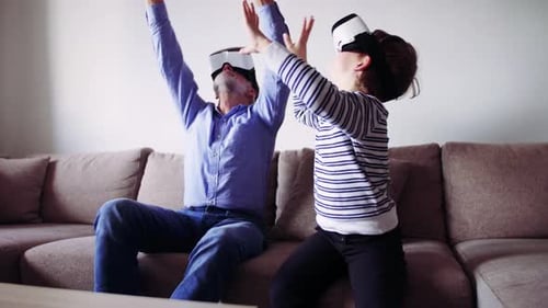 Father and Son play VR games on couch