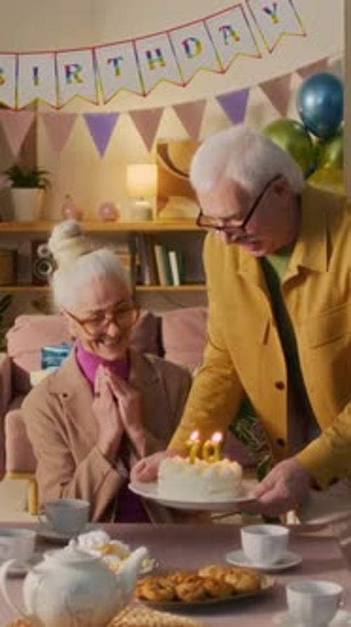 Senior Woman Receives Birthday Cake from Husband