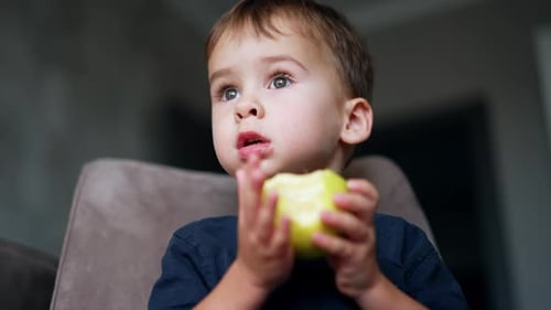 Child Eating Green Apple Close Up