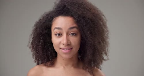 Close Up of Woman with Curly Hair Smiling