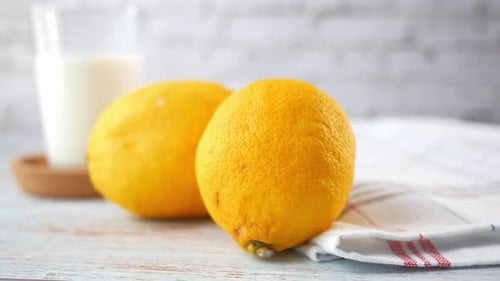 Lemon and Glass of Milk on Table