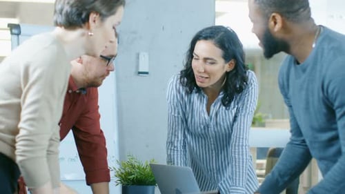 Diverse Team Collaborates in Bright Modern Workplace