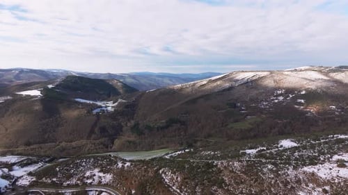Aerial View Of Mountainous Landscape Partly Covered With Snow At The Start Of Winter.