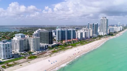 Miami beach flyover captures turquoise ocean and white sand from aerial drone view