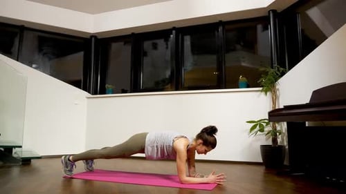 Woman Doing a Forearm Plank in Modern Home
