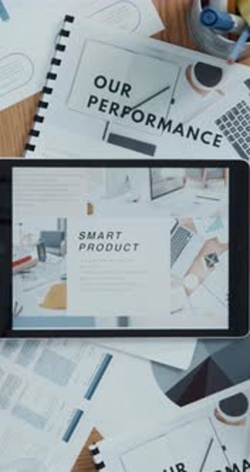 Tablet screen, documents and above for performance with budget report, finance charts