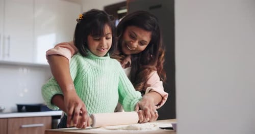 Child and Adult Bake Together in a Sunny Kitchen