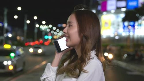 Young Asian Woman Working Use Cellular While Standing in City