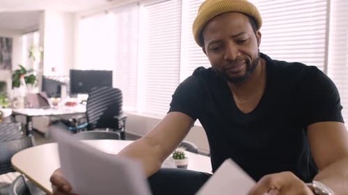 Creative Businessman Reviewing Paperwork in Office 4044 Years