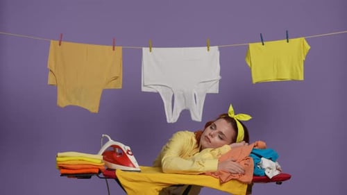 Person Resting Head on Clothes on Ironing Board