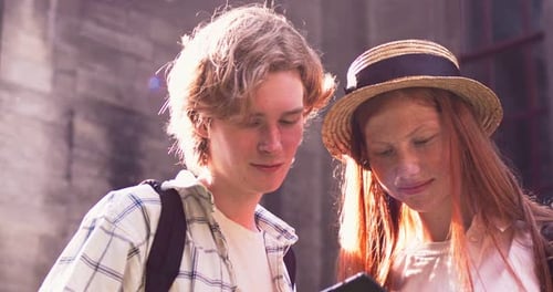 Goodlooking Redheaded Couple Standing on Street and Using Digital Tablet Young Caucasian Best