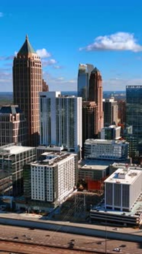 Modern dynamic Atlanta downtown at daytime. Busy traffic in the city by the wide highways.