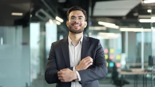 Smiling Professional Businessman Standing in Modern Office