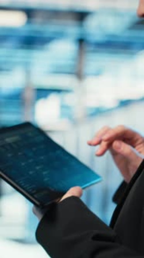 Vertical Video Data Center Programmer Coding on Tablet Optimizing Equipment Rigs