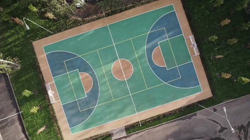 Basketball Court in Downtown Neighborhood Among Trees