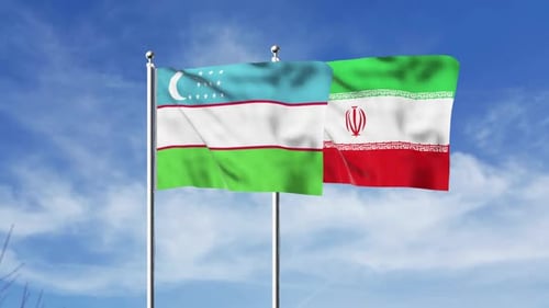 Uzbekistan and Iran Flags Waving Against Blue Sky