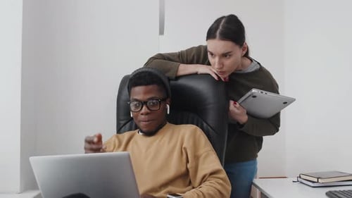 Man And Woman Co-working In Office