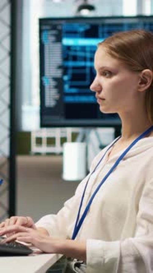 Vertical Video Female Technician Coding with AI Language Model Assistance in Startup Office