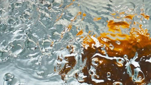 Closeup Oranges Splashing Liquid Top View. Sweet Tropical Fruits Falling Drop Waving