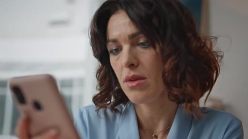 Disappointed Executive Looking Cellphone Message at Office Workplace Closeup