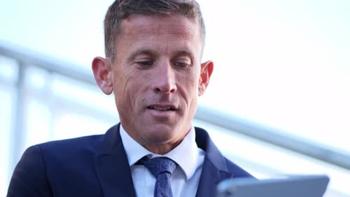 Close Up of Man in Suit Using Tablet