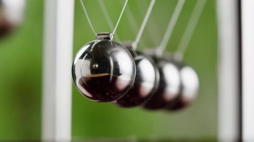 Newton's Cradle Balls Swinging in Macro Shot