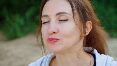 Woman Eating Green Apple with Focused Expression and Calm Demeanor Female Biting Apple While Gazing