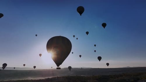 Hot Air Balloons Ascend Over Desert at Sunrise