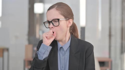 Portrait of Coughing Sick Young Businesswoman in Office
