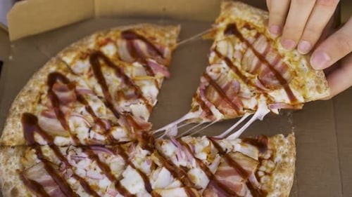Cheesy Pizza Slice Being Lifted From Box