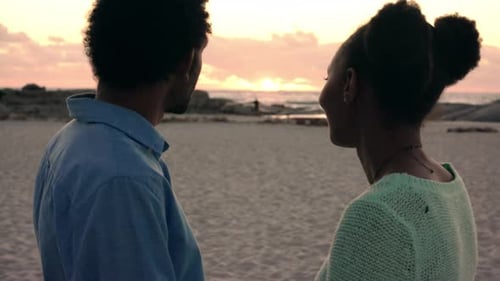 4K video footage of a young couple enjoying a romantic sunset together at the beach