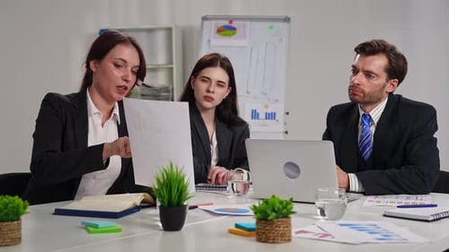 Business Meeting with Three People in Office Setting
