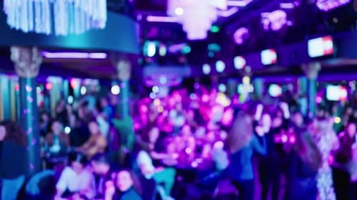Blurred crowd dancing at indoor nightclub party