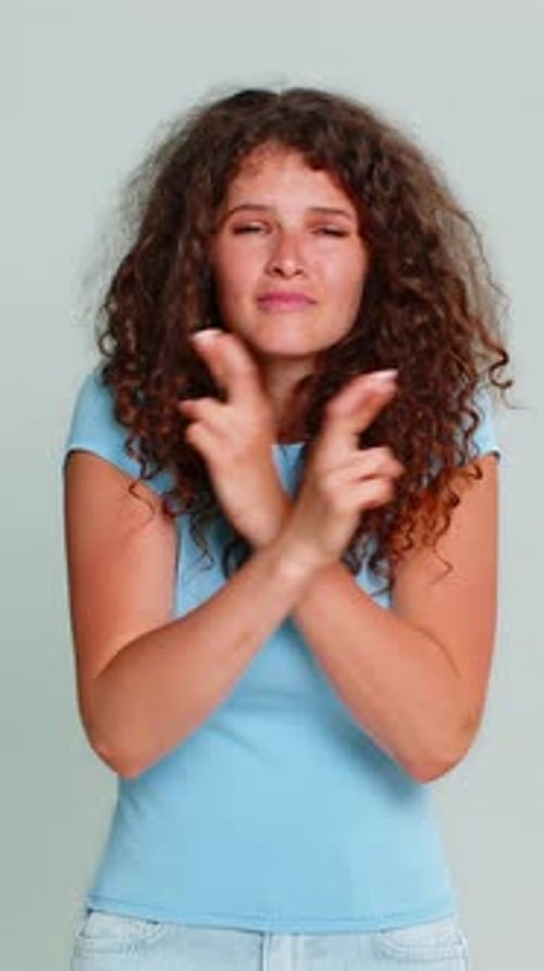Young Woman Smiling Crossing Fingers Hoping Good Luck Wish Positive Optimistic Anticipation Gesture