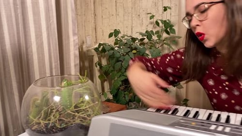 Woman Playing Electronic Keyboard and Singing