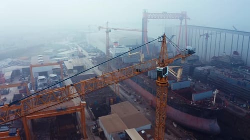Aerial view of shipyard. view of big crane in shipyard. ship building facility. 4K